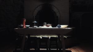 a table in a dark room with dishes on it at Zen Box House in Yangshuo