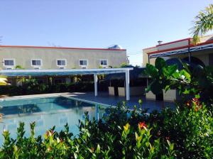 a swimming pool in front of a building at UKL Ever Resort Hotel in Laoag