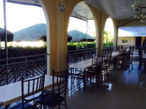 a row of tables and chairs in a restaurant at UKL Ever Resort Hotel in Laoag