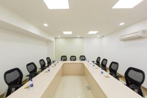 a conference room with a long table and chairs at GINGER Noida City Center in Noida