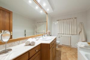a bathroom with a sink and a toilet and a mirror at Can Gual in Inca +34 photos