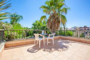 a patio with two chairs and a table on a balcony at Can Gual in Inca
