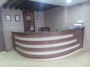 a barber shop with a wooden wall at Hotel Preethi Palace in Ooty