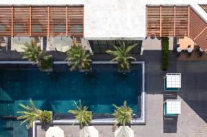 an overhead view of a swimming pool with palm trees at Citadines Bayfront Nha Trang in Nha Trang +64 photos