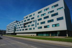 a large white building with a street in front of it at Downtown Hostel in Tartu