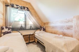 Łóżko lub łóżka w pokoju w obiekcie Apartament Owcze Runo Zakopane