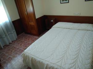 A bed or beds in a room at Hostal Mayo