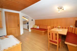 a living room with a table and a dining room at Schöpfhof in Neustift im Stubaital