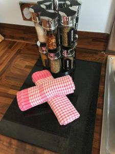 a counter with two pink utensils on top of a table at Riverbank Penthouse and Apartments in Cardiff