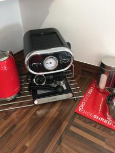 a toaster oven sitting on top of a rack at Riverbank Penthouse and Apartments in Cardiff