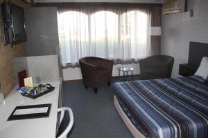 Postel nebo postele na pokoji v ubytování Raglan Motor Inn + 6 fotografií