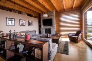 a living room with a couch and a table at Aelia Hospitality Parnassus in Eptalofos