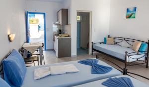 A bed or beds in a room at Iliovasilema VILLAGE