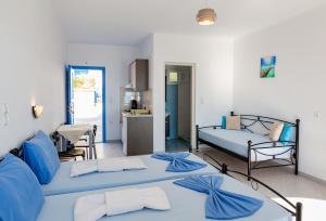 A bed or beds in a room at Iliovasilema VILLAGE