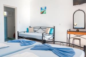 A bed or beds in a room at Iliovasilema VILLAGE