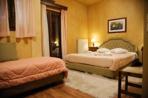 1 Schlafzimmer mit 2 Betten und einem Fenster in der Unterkunft Villa Virginia Hotel in Voútiron