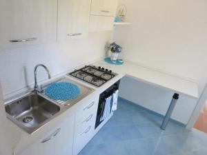 a small kitchen with a sink and a stove at Acquamarina Accommodation in Massa Lubrense