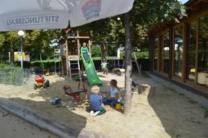 two children playing in the sandbox at a playground at Hotel Daimerwirt in Moosinning