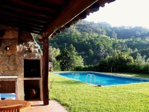 a house with a swimming pool in the grass at Quinta do Jaco in Vieira do Minho