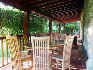 a wooden table and chairs on a patio at Quinta do Jaco in Vieira do Minho