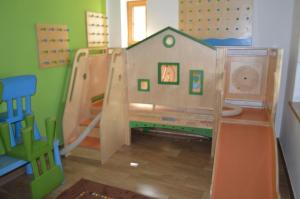 a childs play room with a house on the wall at Hotel Daimerwirt in Moosinning