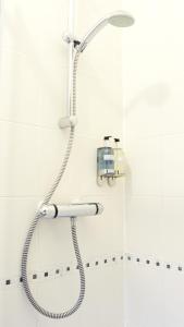 a shower with a shower head in a bathroom at Park Lodge in Farnborough