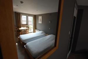 Postel nebo postele na pokoji v ubytování Hotel Piano 2 - Mont-St-Guibert - Louvain-la-Neuve