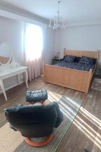 a bedroom with a bed and a couch and a table at Getxo, parking, wifi, metro in Getxo