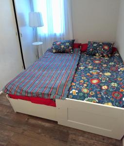 a large bed in a bedroom with a bed frame at Getxo, parking, wifi, metro in Getxo