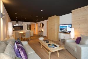 a living room with a couch and a table at Matterhorn Lodge Boutique Hotel & Apartments in Zermatt