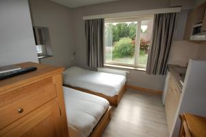Postel nebo postele na pokoji v ubytování Hotel Piano 2 - Mont-St-Guibert - Louvain-la-Neuve