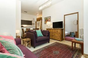 a living room with a purple couch and a tv at Apartment Majestic 1 in Chamonix-Mont-Blanc
