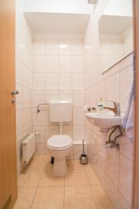a bathroom with a toilet and a sink at Center Ház Apartman in Budapest