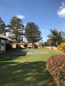 a yard with a small pond in the middle of a field at Ian and Pam's Flatlet in Empangeni
