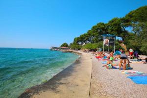 a group of people on a beach near the water at Lavender Suite Zadar in Zadar