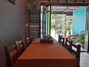 a dining room with a long table with orange table cloth at Muster Guesthouse in Phra Nakhon Si Ayutthaya +26 photos