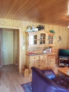a living room with a couch and a tv in a cabin at Ferienwohnung Duinli in Fiesch