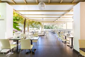 an empty dining room with tables and chairs at Xidas Garden in Bali
