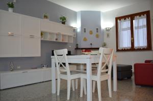 a kitchen with a white table and two chairs at Domusangeladue in Matera