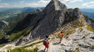 two people walking on a rocky mountain at Gästehaus Temitzhof in Latschach