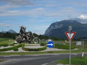 a statue of two people on a motorcycle on a road at Gästehaus Temitzhof in Latschach