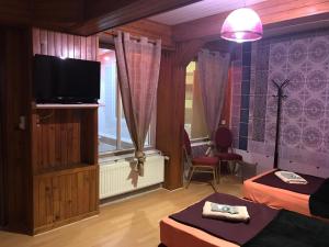 a room with two beds and a flat screen tv at Gite *Anzi* in Arcis-sur-Aube