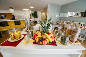 a table with a plate of fruit on it at STAY.inn Comfort Art Hotel Schwaz in Schwaz