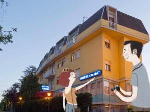 a building with a mural of a man and a woman at Hotel Gloria in Salsomaggiore Terme