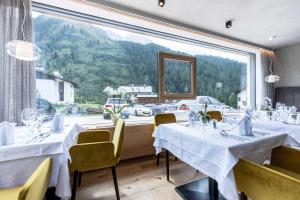 a restaurant with two tables and a large window at Hotel Eden in Solda