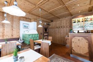 ein Restaurant mit Holzwänden sowie Holztischen und -stühlen in der Unterkunft Hotel Eden in Sulden