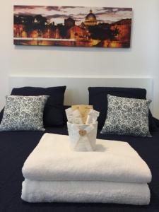 a bed with a box of tissues on top of it at Aquarius Rome in Mostacciano 