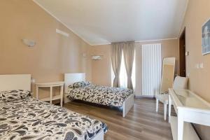 um quarto de hotel com duas camas e uma janela em Villa Mereghetti em Corbetta