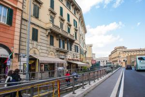 a group of people walking down a street next to buildings at Holiday Home House Fornaci in Rome