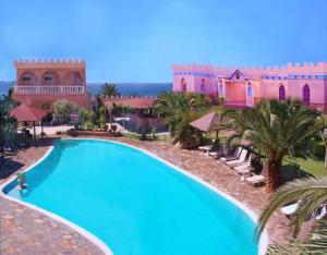 a swimming pool in front of a building at Villa Pappas in Kanali